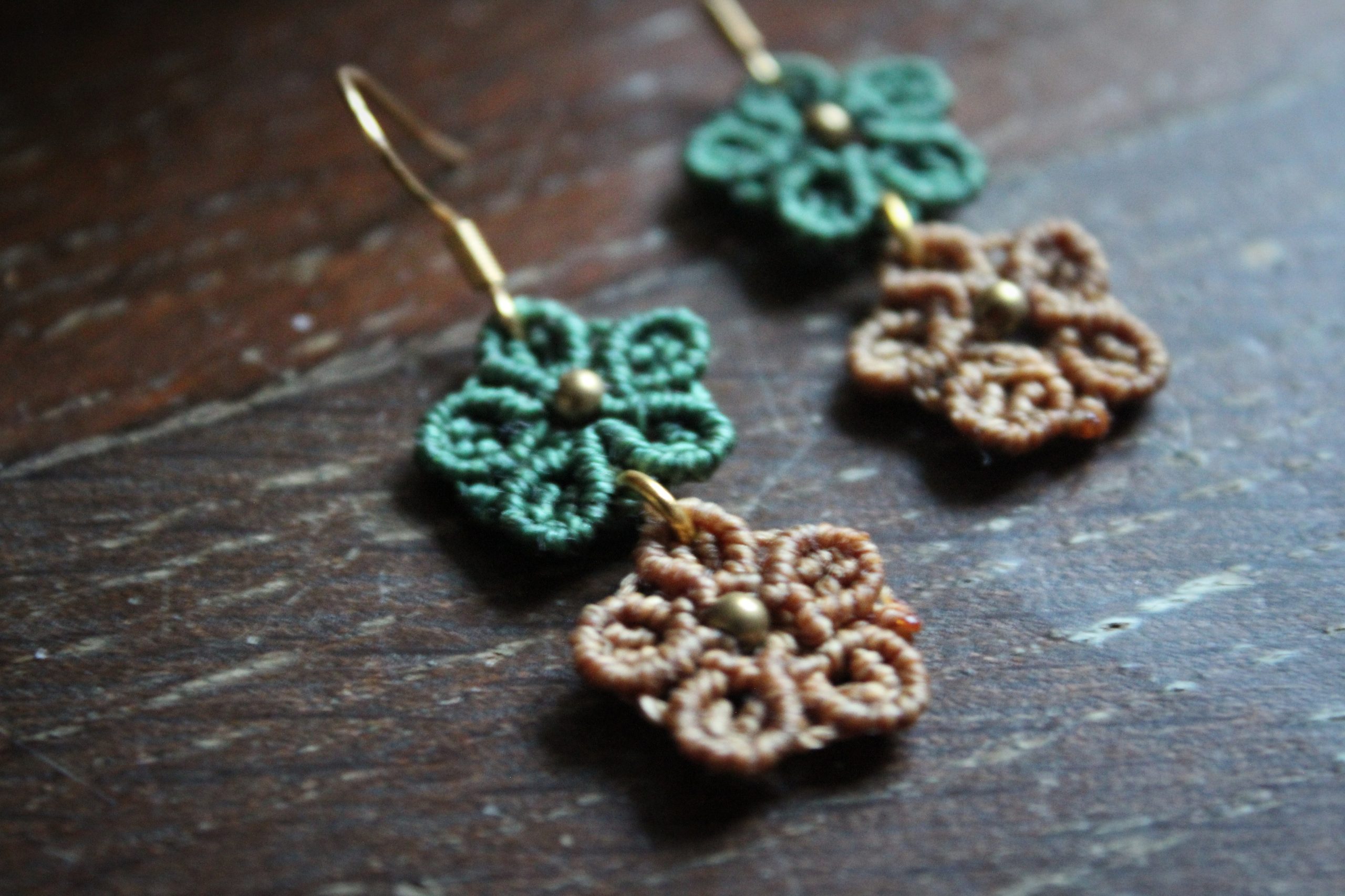 Boucles d'oreilles en micro macramé représentant des fleurs vertes et moutarde