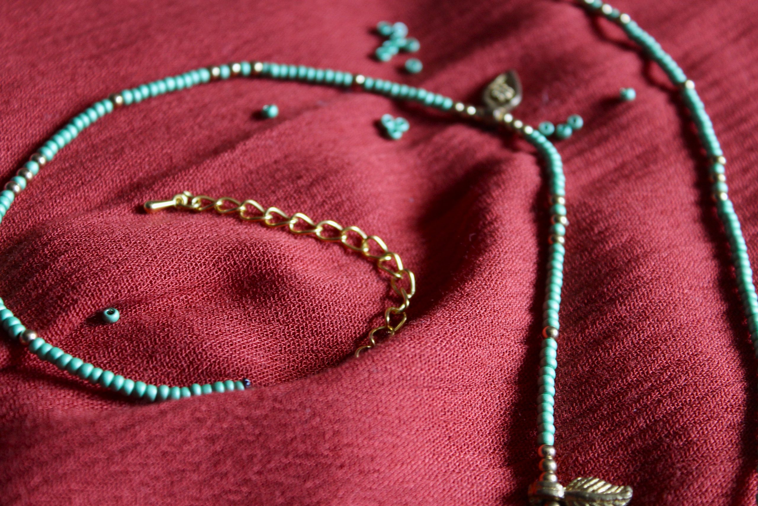 Bijou de taille avec des perles vertes et breloques dorées tibétaines